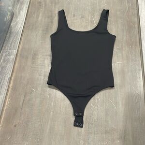Women’s black thong body suit in size small.